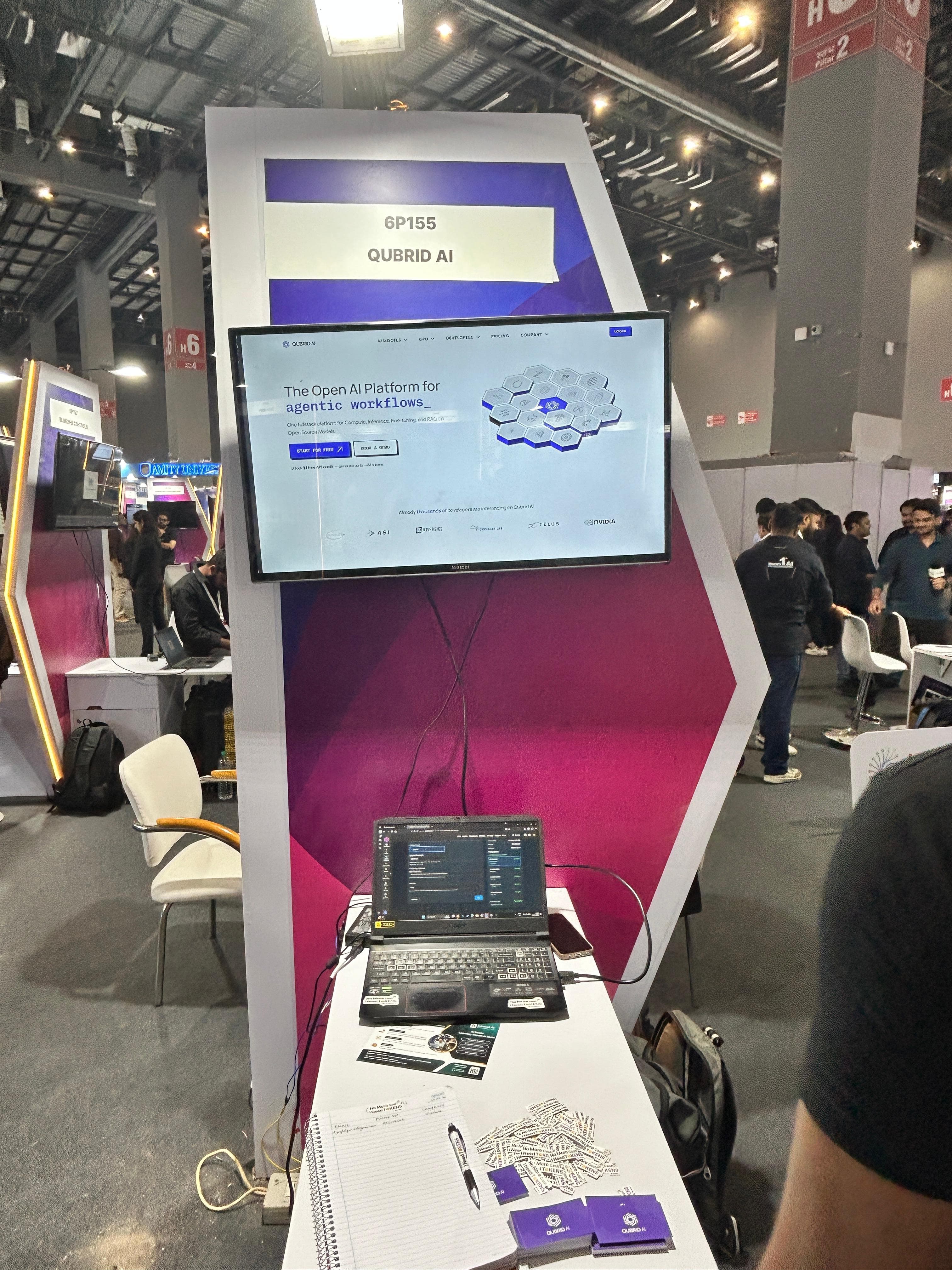 Qubrid AI booth (6P155) with the platform demo on screen
